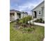 A well-maintained lawn and landscaped garden bed enhances the curb appeal of this single-Gathering home at 1791 Post Oak Dr, Davenport, FL 33837