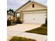 A two-car garage with a concrete driveway enhances the exterior of this single-Gathering home at 1791 Post Oak Dr, Davenport, FL 33837