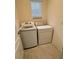 A convenient laundry room equipped with a washing machine and dryer offers ease for laundry tasks at 1791 Post Oak Dr, Davenport, FL 33837