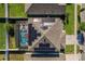 Aerial view of home featuring a screened pool, solar panels and fenced yard at 1809 Bluepoint St, St Cloud, FL 34771