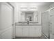 Elegant bathroom featuring a double vanity, granite countertops, a glass-enclosed shower, and ample lighting at 1809 Bluepoint St, St Cloud, FL 34771