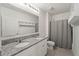 Bathroom featuring double sink vanity with granite countertop, toilet, and shower/tub combo at 1809 Bluepoint St, St Cloud, FL 34771