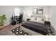 Modern bedroom featuring a tufted headboard, neutral decor, and a sleek computer gaming setup, creating a comfortable and stylish space at 1809 Bluepoint St, St Cloud, FL 34771
