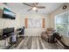 Bright bedroom with modern ceiling fan, workstation, and comfortable seating by window at 1809 Bluepoint St, St Cloud, FL 34771