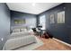 This bedroom features a comfortable bed, neutral tones, and a dedicated workspace with a computer at 1809 Bluepoint St, St Cloud, FL 34771