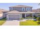 Beautiful two-story home featuring a well-maintained lawn, charming landscaping, and attached two-car garage at 1809 Bluepoint St, St Cloud, FL 34771