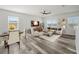 Spacious living room with hardwood floors, a ceiling fan, and plenty of natural light at 1809 Bluepoint St, St Cloud, FL 34771