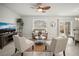 Cozy living room featuring neutral tones, ample seating, a ceiling fan, and sliding door access to the patio at 1809 Bluepoint St, St Cloud, FL 34771
