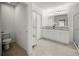 Bright bathroom with double vanity, granite countertops, tile flooring, and a separate toilet room at 1809 Bluepoint St, St Cloud, FL 34771