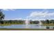 Picturesque view of the community pond with fountain and lush landscaping at 1809 Bluepoint St, St Cloud, FL 34771