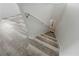 View of the staircase with stylish, light-colored wood-look flooring and white painted walls at 1809 Bluepoint St, St Cloud, FL 34771