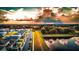 Scenic neighborhood street view with pond, lush trees and warm sky at 1809 Bluepoint St, St Cloud, FL 34771