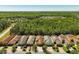 A neighborhood with well-manicured lawns, tree lined streets, and beautiful homes is seen from above at 1825 Pelican Hill Way, Kissimmee, FL 34759