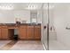 Bathroom with double vanities, framed mirrors, a glass-enclosed shower, and neutral-colored walls at 1825 Pelican Hill Way, Kissimmee, FL 34759