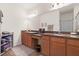 Well-lit bathroom featuring dual sinks, granite countertops, and ample cabinet space, perfect for a functional and stylish space at 1825 Pelican Hill Way, Kissimmee, FL 34759