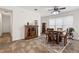 Inviting dining area with stylish decor, wooden furniture, and complementary tile flooring, great for entertaining at 1825 Pelican Hill Way, Kissimmee, FL 34759