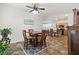 A cozy dining area features a wooden table with seating for four, tile flooring, and stylish overhead lighting at 1825 Pelican Hill Way, Kissimmee, FL 34759
