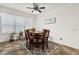 Dining area showcasing a wooden table, chair set, overhead lighting, and a window for natural light at 1825 Pelican Hill Way, Kissimmee, FL 34759