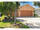 Charming home featuring a three-car garage and a meticulously paved driveway, offering curb appeal at 1825 Pelican Hill Way, Kissimmee, FL 34759