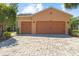 Charming home featuring a three-car garage and a meticulously paved driveway, offering curb appeal at 1825 Pelican Hill Way, Kissimmee, FL 34759