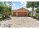 Charming home featuring a three-car garage and a meticulously paved driveway, offering curb appeal at 1825 Pelican Hill Way, Kissimmee, FL 34759