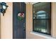 Exterior view of a front door with floral wreath and black trim near a window with blinds at 1825 Pelican Hill Way, Kissimmee, FL 34759