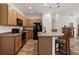 Well-appointed kitchen featuring stainless steel appliances, wooden cabinets, and a breakfast bar for extra seating at 1825 Pelican Hill Way, Kissimmee, FL 34759