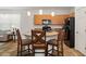 Kitchen with a center island and bar seating, featuring modern appliances and neutral-colored cabinets at 1825 Pelican Hill Way, Kissimmee, FL 34759