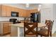 Stylish kitchen boasting ample cabinet space, black appliances, and a cozy breakfast bar for casual dining at 1825 Pelican Hill Way, Kissimmee, FL 34759