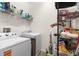 Functional laundry room with washer, dryer, shelving and extra storage, designed for convenience and organization at 1825 Pelican Hill Way, Kissimmee, FL 34759