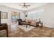 Open living room with natural light, a cozy sofa, and a view of the outdoor screened-in patio at 1825 Pelican Hill Way, Kissimmee, FL 34759