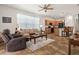 Inviting living room open to the kitchen, featuring comfortable seating and a view of the modern appliances at 1825 Pelican Hill Way, Kissimmee, FL 34759