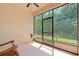 Enjoy this screened patio with a ceiling fan, table, and outside view through the screen at 1825 Pelican Hill Way, Kissimmee, FL 34759