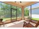 Relaxing screened porch overlooking a lush backyard, providing a peaceful outdoor retreat with comfortable seating and natural light at 1825 Pelican Hill Way, Kissimmee, FL 34759