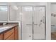 Modern walk-in shower with glass enclosure and tiled walls, providing a clean and contemporary bathing experience at 1825 Pelican Hill Way, Kissimmee, FL 34759
