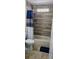 Bathroom featuring a shower with a blue shower curtain, gray tiled wall, and tile flooring at 2049 Shannon Lakes Blvd, Kissimmee, FL 34743