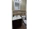 Bathroom featuring white sink with dark wood cabinet, matching backsplash, and a toilet at 2049 Shannon Lakes Blvd, Kissimmee, FL 34743