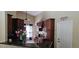 Cozy kitchen featuring dark wood cabinets, granite countertops, and stainless steel appliances at 2049 Shannon Lakes Blvd, Kissimmee, FL 34743