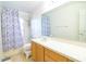 Bathroom with a large vanity and shower/tub combo with a floral shower curtain at 2110 Korat Ln, Maitland, FL 32751