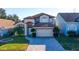 Charming two-story home featuring an attached two-car garage and a meticulously maintained front yard at 2110 Korat Ln, Maitland, FL 32751