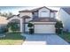 Beautiful two-story home showcasing a two-car garage, a paved driveway, and manicured landscaping at 2110 Korat Ln, Maitland, FL 32751