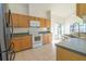 Bright kitchen featuring wooden cabinets, a window with a view, and ample counter space at 2110 Korat Ln, Maitland, FL 32751