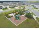 Aerial view of community playground with lush landscaping and Gathering friendly amenities in a neighborhood at 2279 Raven Ridge Road, Minneola, FL 34715