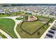 Aerial view of community featuring playground, green space, walking paths, and dog park at 2279 Raven Ridge Road, Minneola, FL 34715