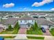 Aerial view of a beautiful home showcasing its brick driveway, landscaping, and the surrounding neighborhood at 2279 Raven Ridge Road, Minneola, FL 34715