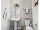 Charming powder room with pedestal sink, oval mirror, and neutral decor at 2279 Raven Ridge Road, Minneola, FL 34715