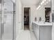 Modern bathroom with double vanity and walk-in shower with decorative tile at 2279 Raven Ridge Road, Minneola, FL 34715