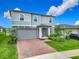 Charming two-story home with a well-manicured lawn, brick driveway and a two-car garage at 2279 Raven Ridge Road, Minneola, FL 34715