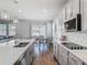 Bright kitchen view with stainless steel appliances, kitchen island and dining area at 2279 Raven Ridge Road, Minneola, FL 34715
