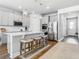 Bright kitchen featuring a quartz island, pendant lighting, and stainless steel appliances at 2279 Raven Ridge Road, Minneola, FL 34715